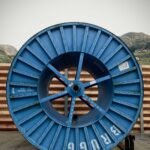 blue and black round wheel on brown wooden dock during daytime