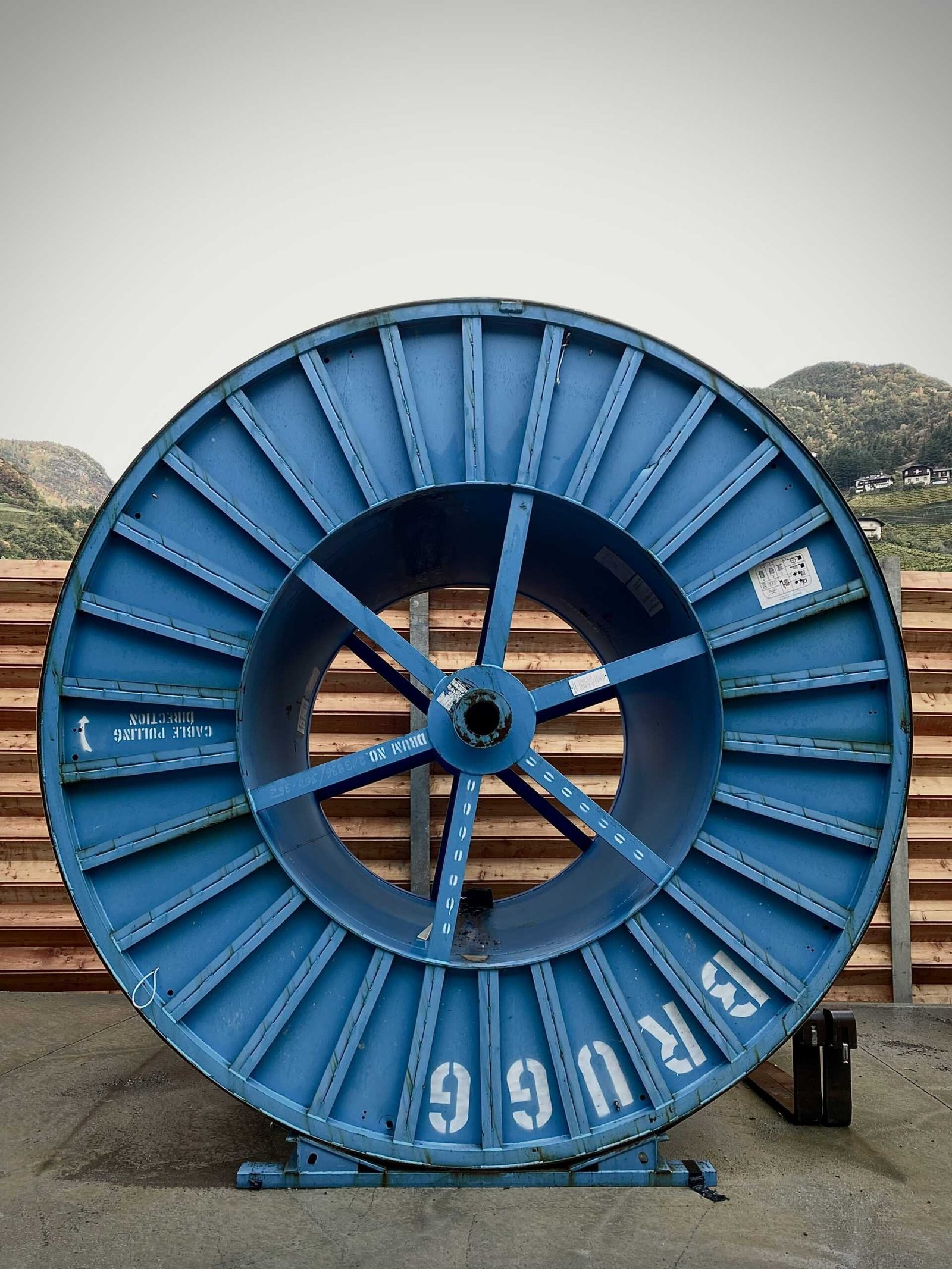 blue and black round wheel on brown wooden dock during daytime